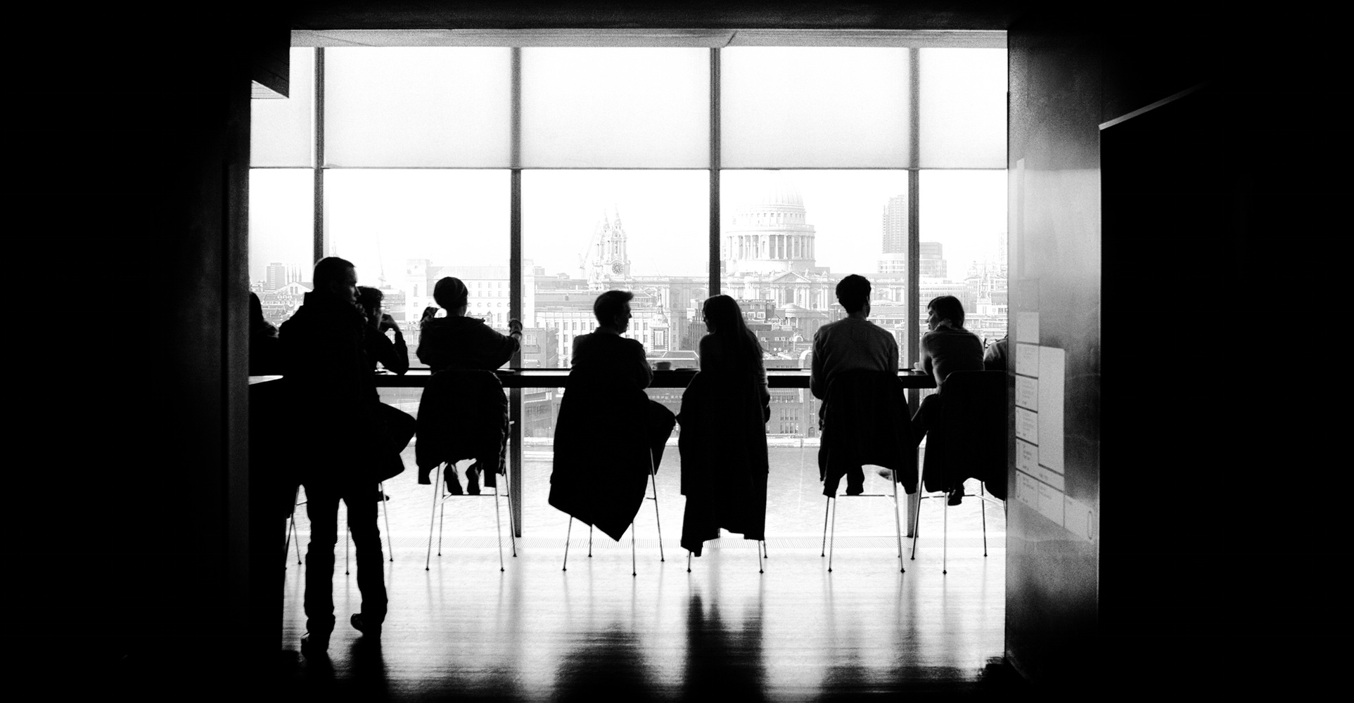 Black and white photo of people by windows with clear design